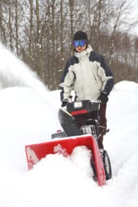 Man with snow thrower