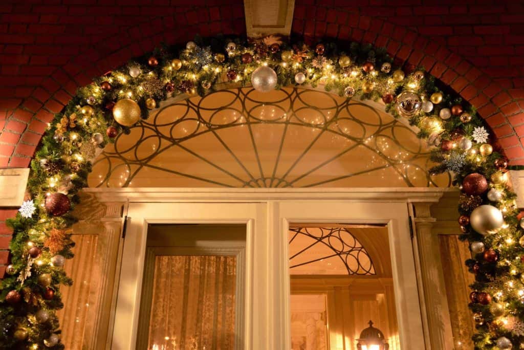 illuminated holiday garland archway over door