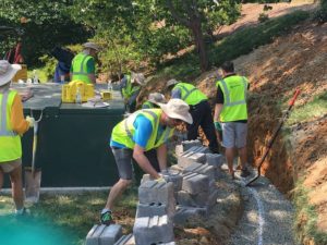 workers building retaining wall