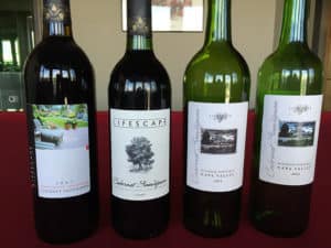 four red wine bottles