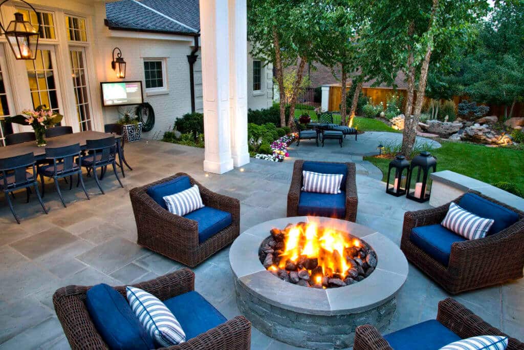 cozy outdoor patio with a fire pit and blue cushions