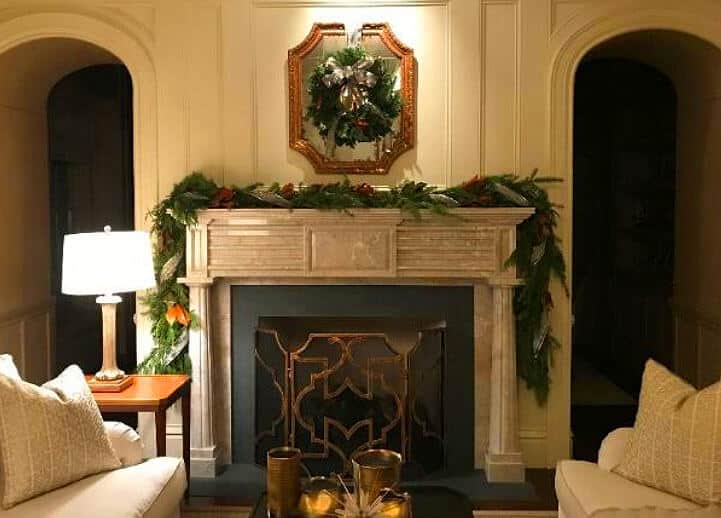 fireplace mantel with holiday garland and wreath