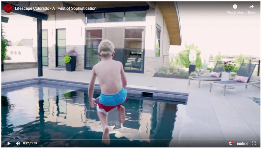 boy jumping into swimming pool