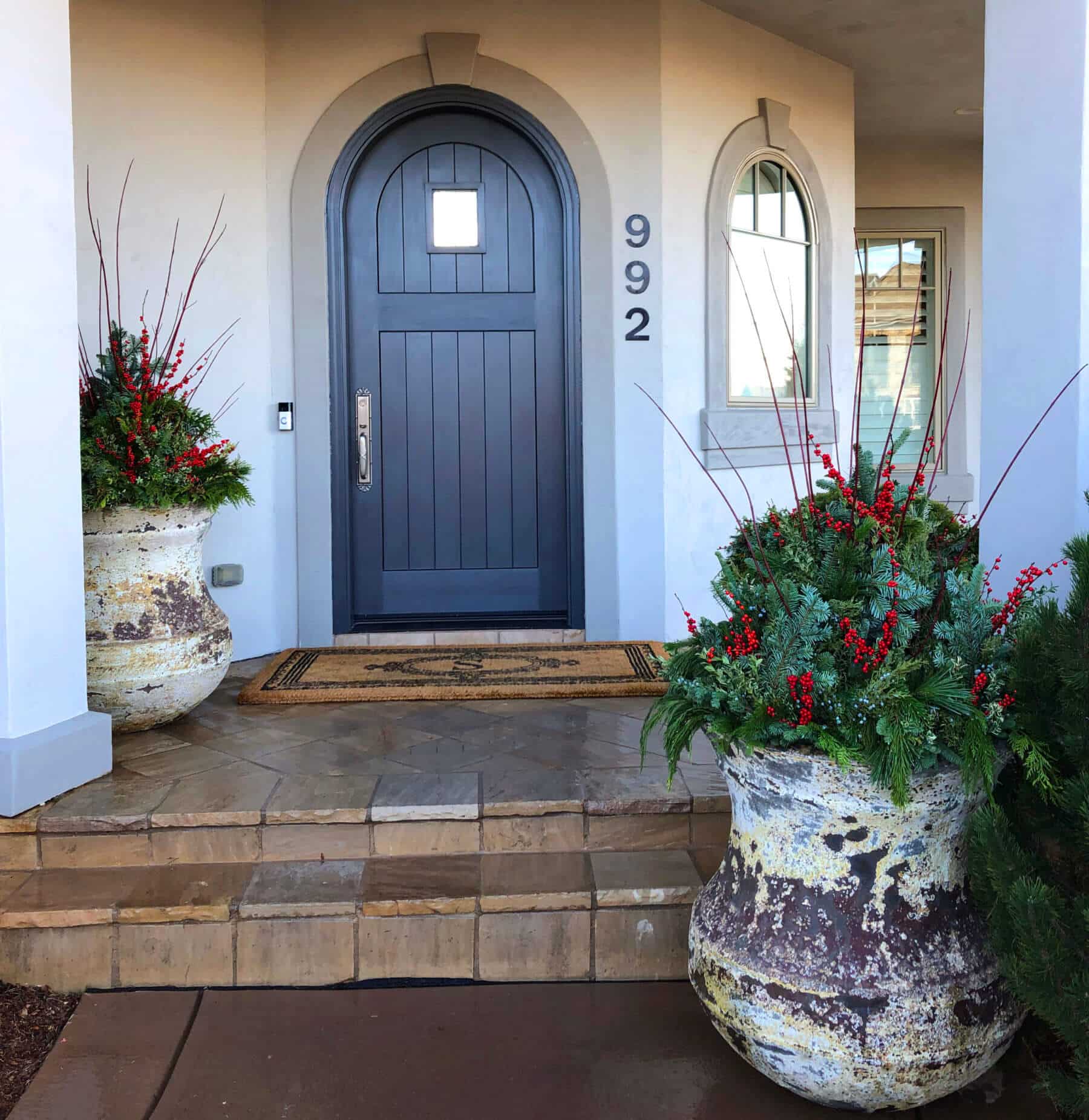 front door entrance with holiday planters