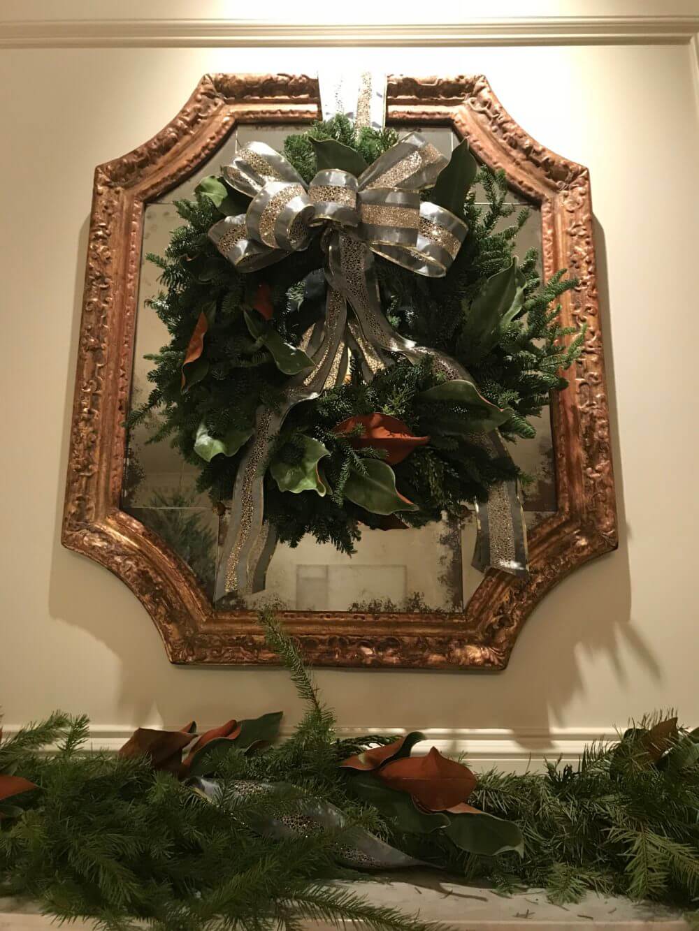 holiday wreath on gold framed mirror