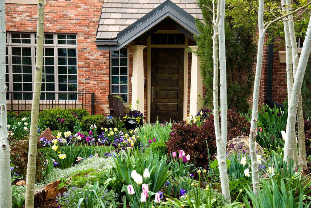front yard garden with blooming spring bulbs and perennials,