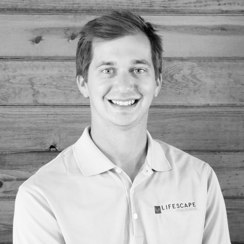 black and white portrait of a young man smiling