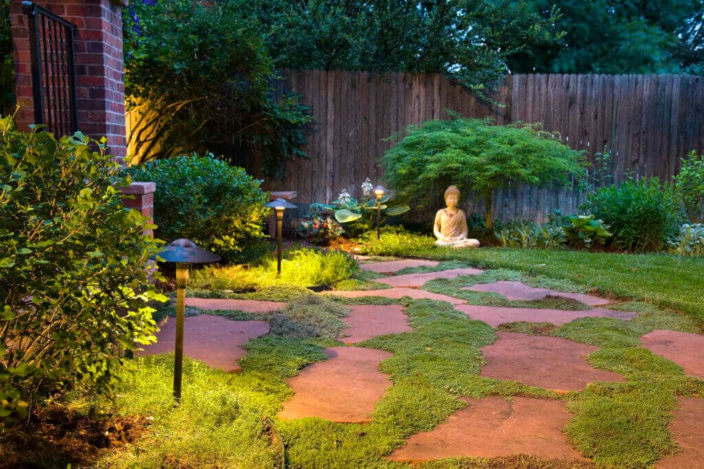 serene evening garden path made of irregular orange-toned flagstones