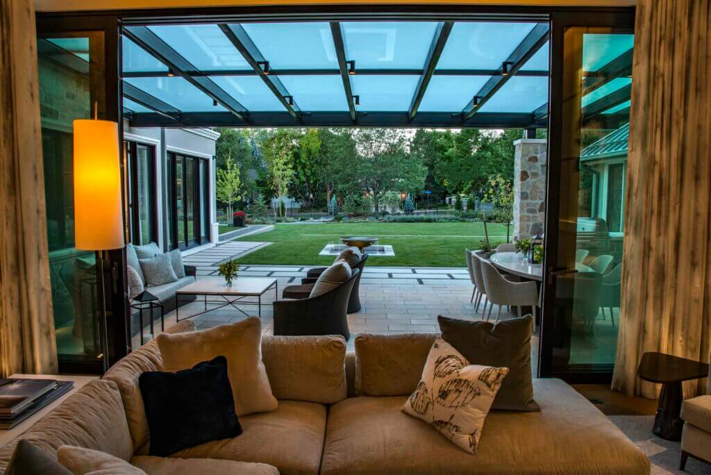 living room overlooks lush green backyard