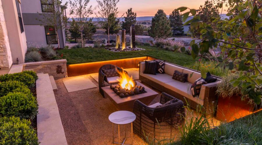 fire pit glows on modern patio