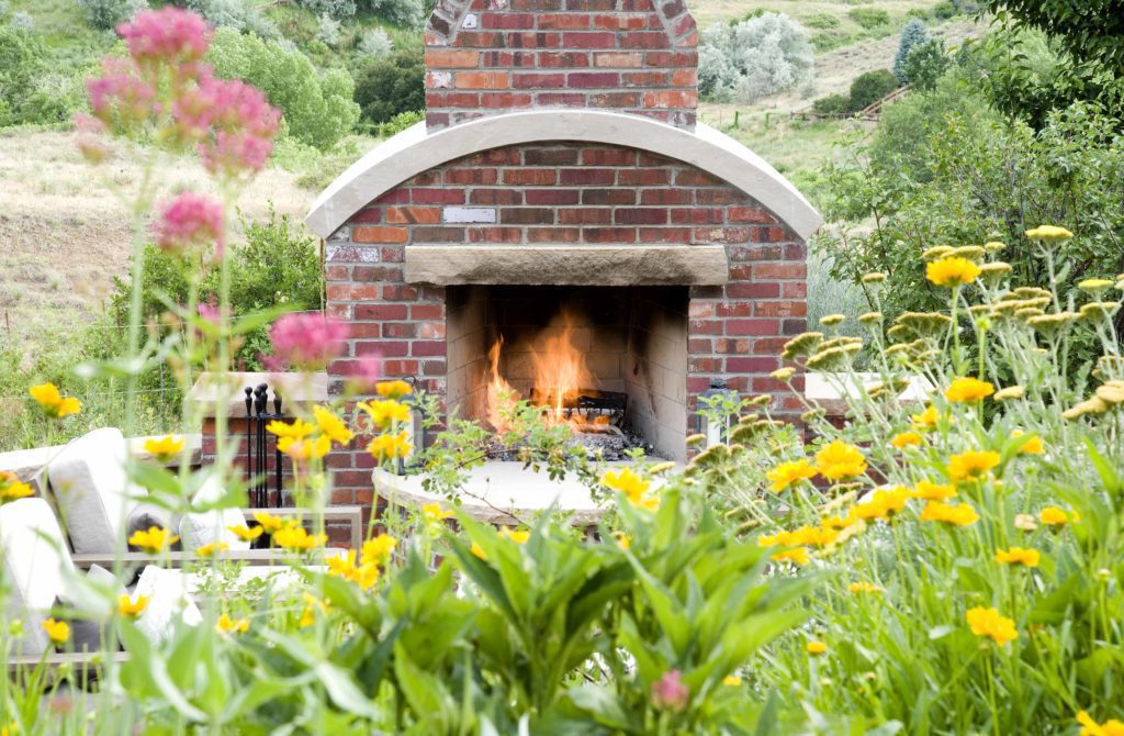 brick fireplace warms outdoor garden