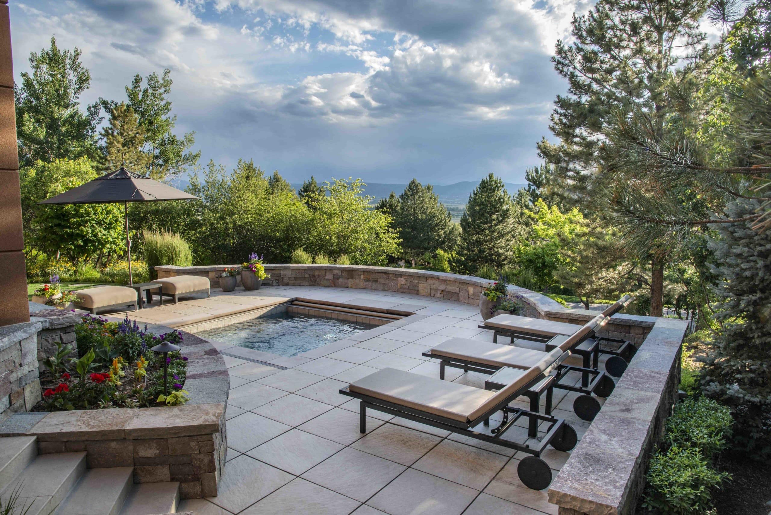 landscape design features a high-end outdoor pool and patio area