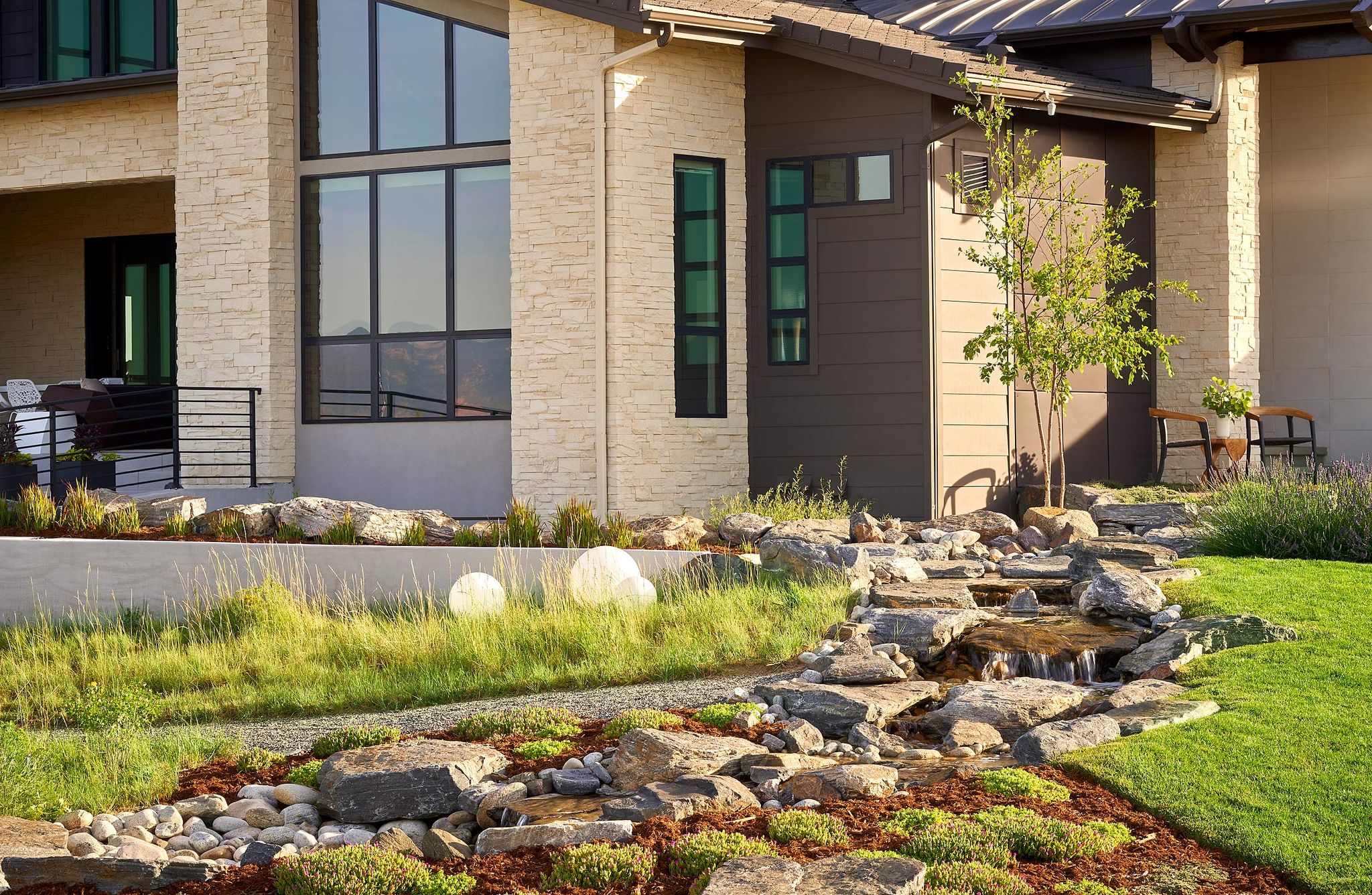 natural rocky stream beside modern house