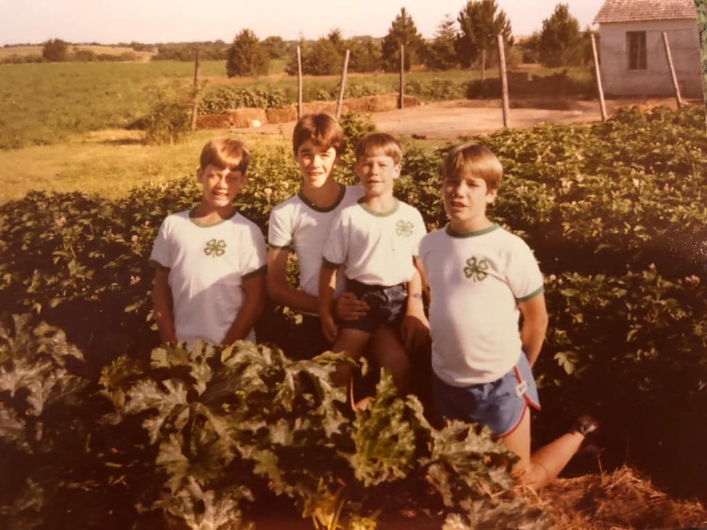 four boys posing in garden