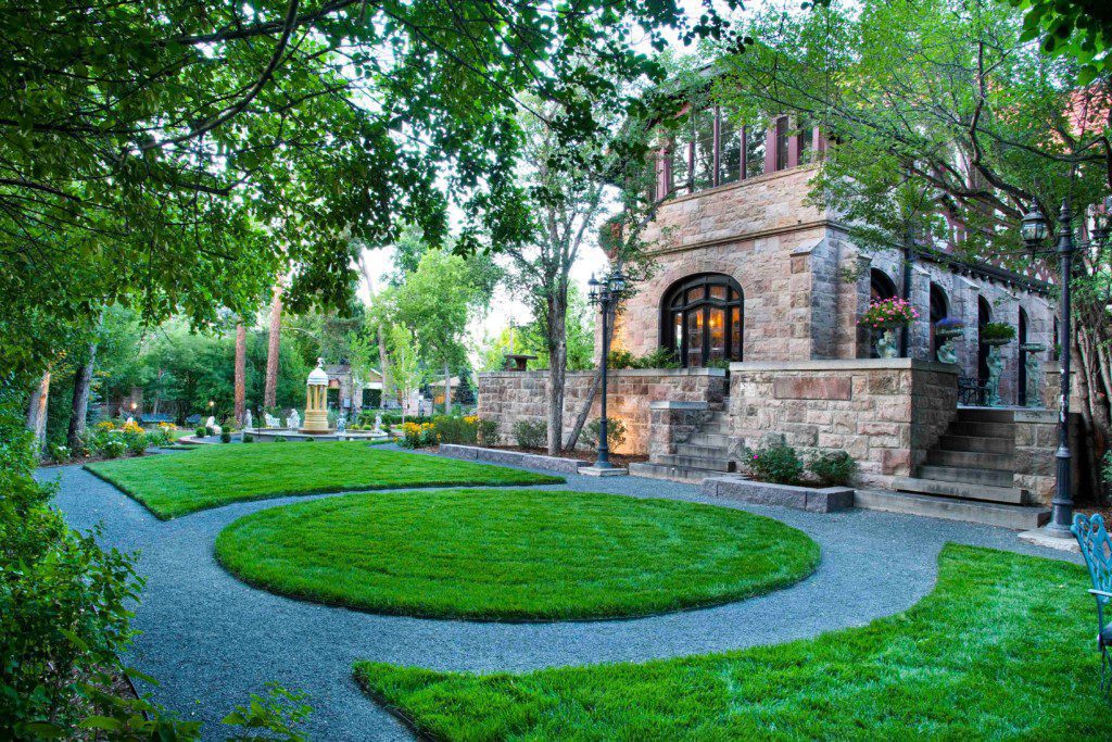 circular lawn and stone house