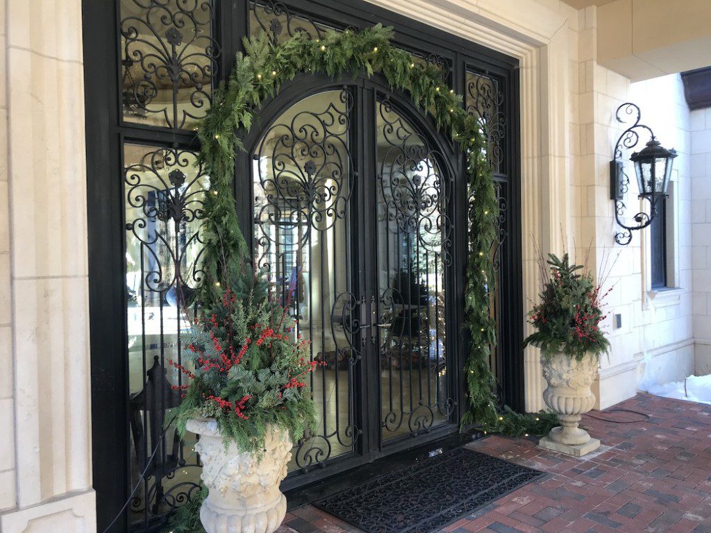 garland surrounds ornate black doors